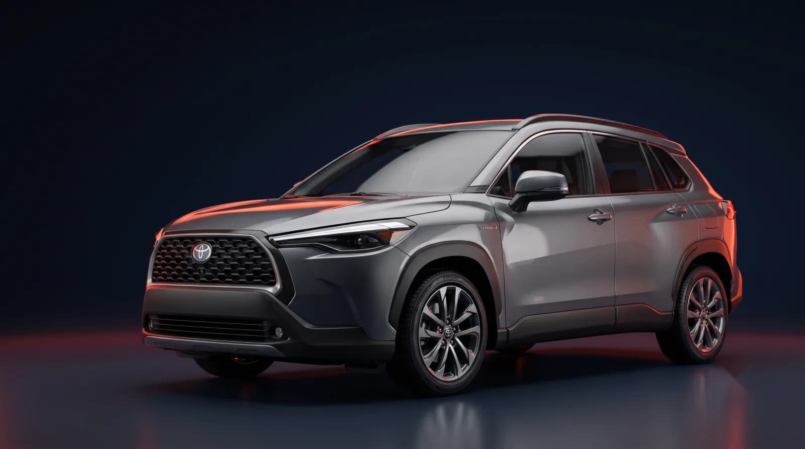 2022–2025 Toyota Corolla Cross Hybrid SUV — studio photo on a dark navy backdrop with vermilion accent lighting
